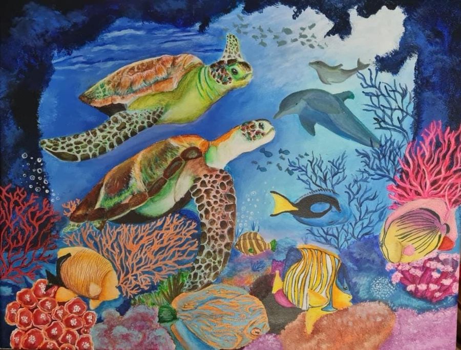 Two sea turtles swimming over a colourful coral reef with dolphins and tropical fish